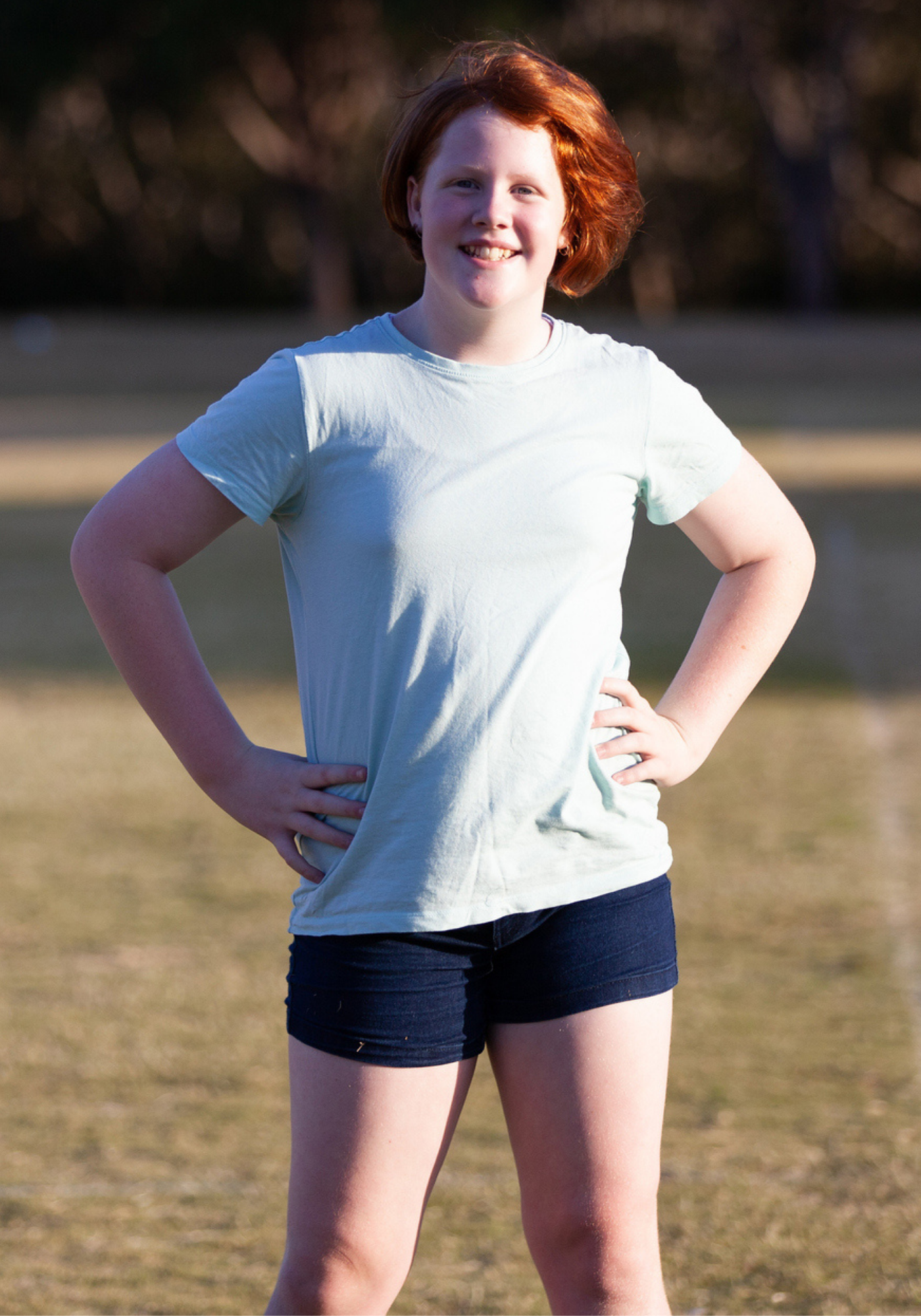 Teenager poses for the camera on a soccer field